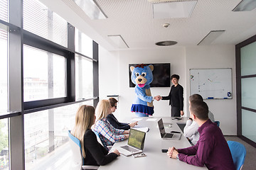 Image showing boss dresed as bear having fun with business people in trendy of