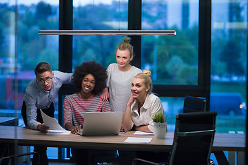 Image showing Multiethnic startup business team in night office