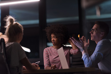 Image showing Multiethnic startup business team in night office