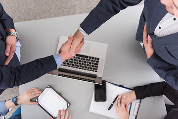 Image showing cloasing the deal in modern office interior top view