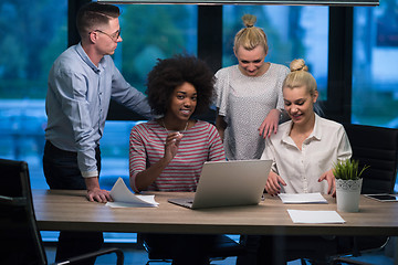 Image showing Multiethnic startup business team in night office