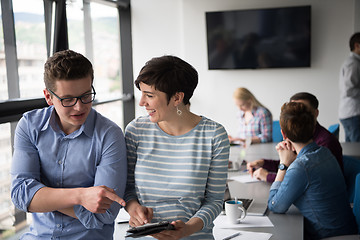 Image showing Two Business People Working With Tablet in office