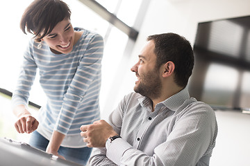 Image showing Two Business People Working With Tablet in startup office