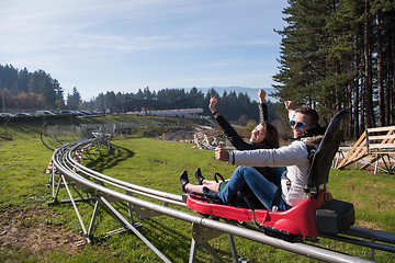 Image showing couple enjoys driving on alpine coaster