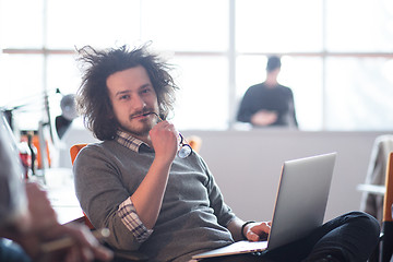 Image showing businessman working using a laptop in startup office