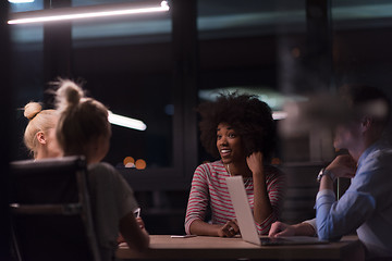 Image showing Multiethnic startup business team in night office