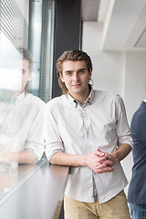 Image showing young businessman in startup office by the window