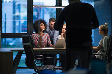 Image showing Multiethnic startup business team in night office