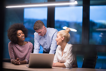 Image showing Multiethnic startup business team in night office