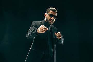 Image showing The barded man in a suit at black studio