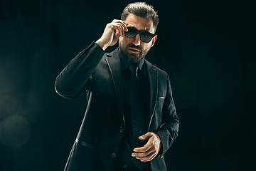 Image showing The barded man in a suit at black studio