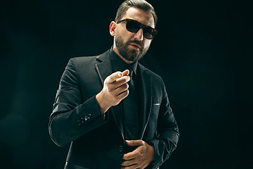 Image showing The barded man in a suit at black studio