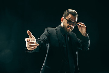 Image showing The barded man in a suit at black studio