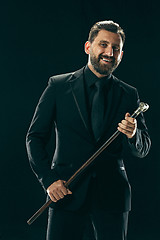 Image showing The barded man in a suit holding cane.