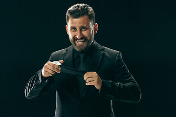 Image showing The barded man in a suit at black studio