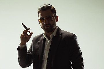 Image showing The barded man in a suit holding cigar