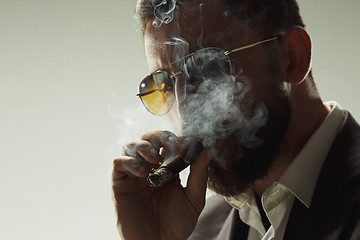 Image showing The barded man in a suit holding cigar