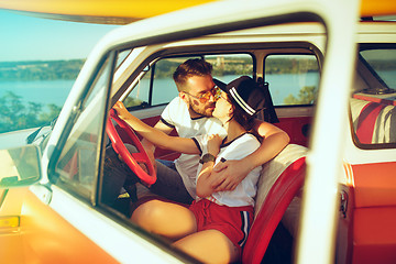 Image showing Laughing romantic couple sitting in car while out on a road trip at summer day