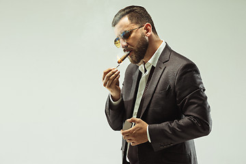 Image showing The barded man in a suit holding cigar