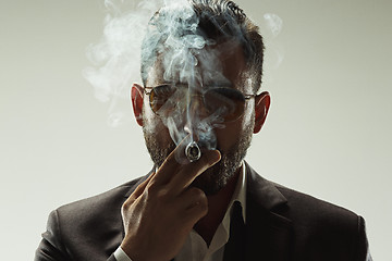 Image showing The barded man in a suit holding cigar