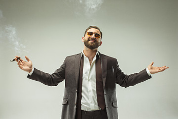 Image showing The barded man in a suit holding cigar