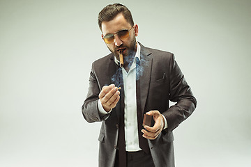 Image showing The barded man in a suit holding cigar