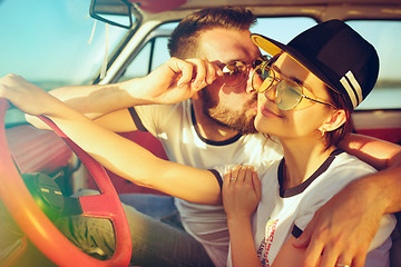 Image showing Laughing romantic couple sitting in car while out on a road trip at summer day