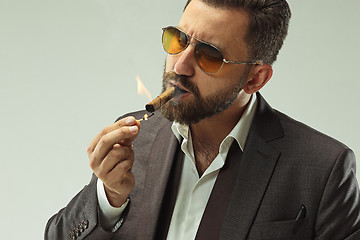 Image showing The barded man in a suit holding cigar