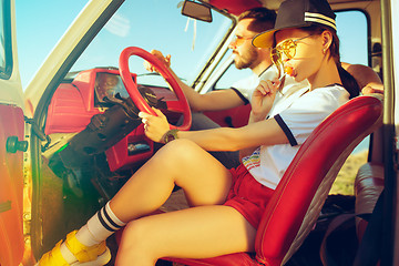 Image showing Laughing romantic couple sitting in car while out on a road trip at summer day