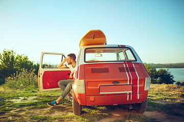 Image showing Man resting on the beach on a summer day near river