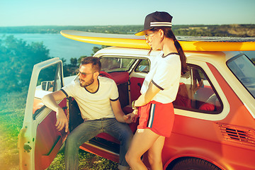 Image showing Couple resting on the beach on a summer day near river