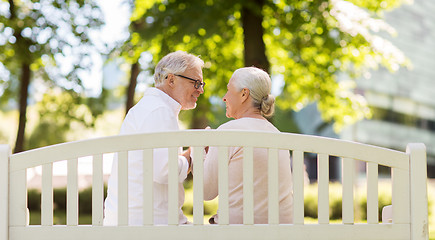 Image showing happy senior couple sitting on park bench