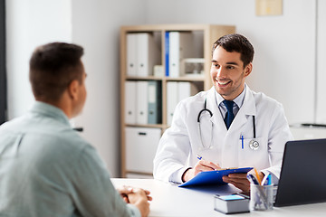 Image showing doctor with clipboard and male patient at hospital