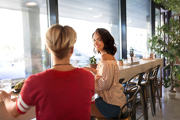 Image showing female friends eating at restaurant