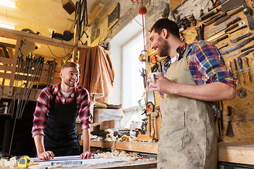 Image showing carpenters with ruler and coffee at workshop