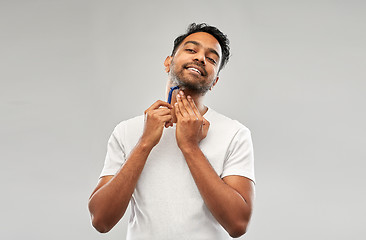 Image showing indian man shaving beard with razor blade