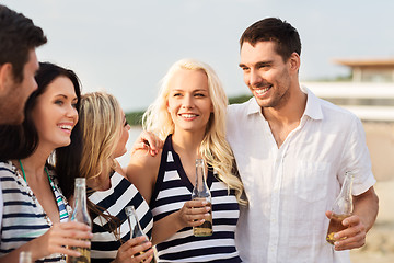 Image showing happy friends drinking non alcoholic beer on beach