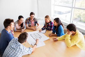 Image showing group of smiling students with blueprint