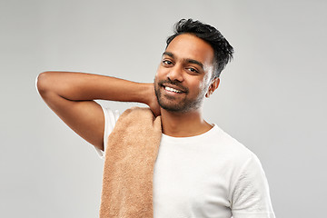 Image showing smiling indian man with towel over grey background