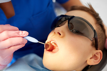 Image showing boy having teeth checkup at dental clinic