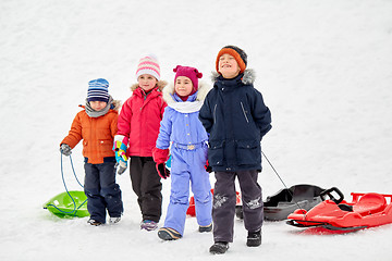 Image showing happy little kids with sleds in winter