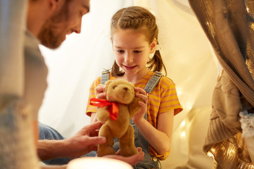 Image showing happy family playing with toy in kids tent at home