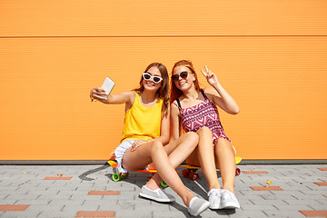 Image showing teenage girls with skateboards taking selfie