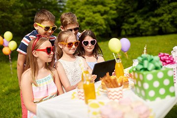 Image showing happy kids with tablet pc on birthday party