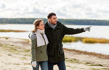 Image showing couple walking along autumn beach