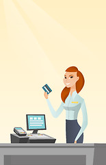 Image showing Caucasian cashier holding a credit card.