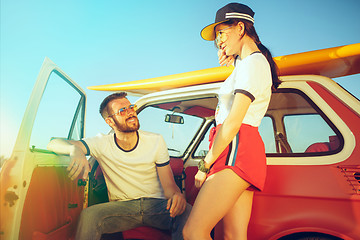 Image showing Couple resting on the beach on a summer day near river