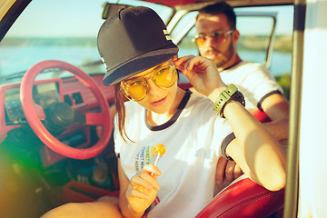 Image showing Laughing romantic couple sitting in car while out on a road trip