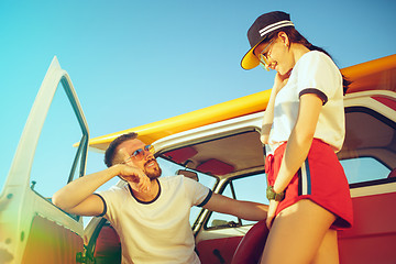 Image showing Couple resting on the beach on a summer day near river