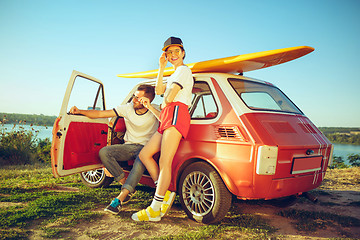 Image showing Couple resting on the beach on a summer day near river